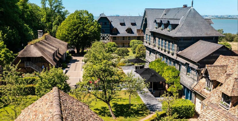 Monet's La Ferme saint Siméon: rustic venue for events, lush greenery, ideal for meetings.