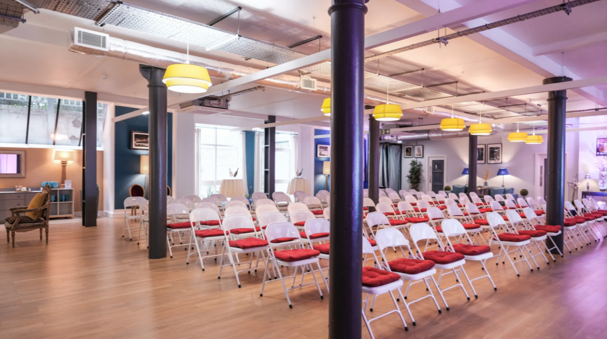 Event space at La Galeria with stylish red-cushioned chairs for meetings and presentations. - Banner