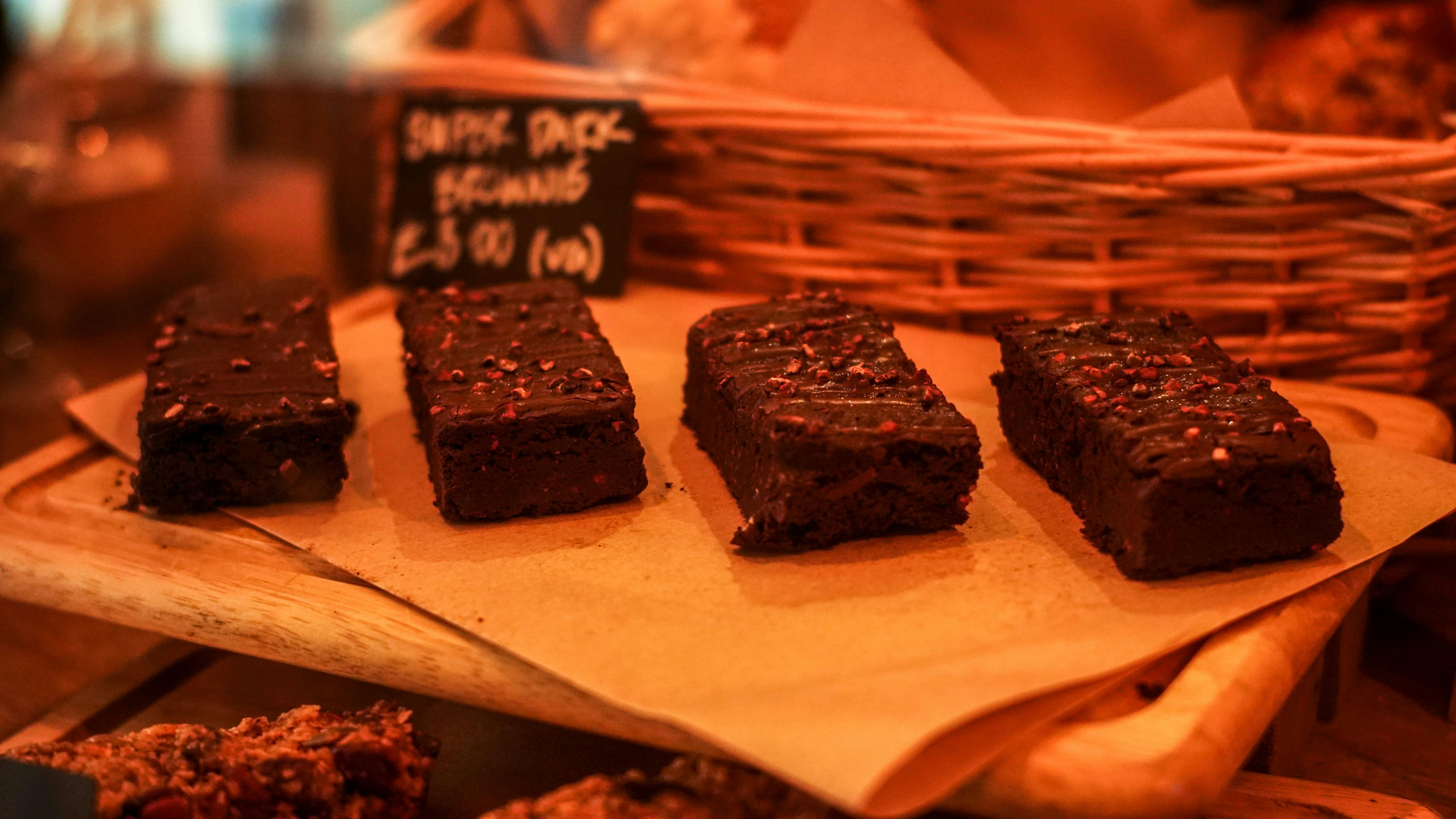 Chocolate brownies on rustic board at Cloak Cafe, perfect for event catering and coffee breaks.
