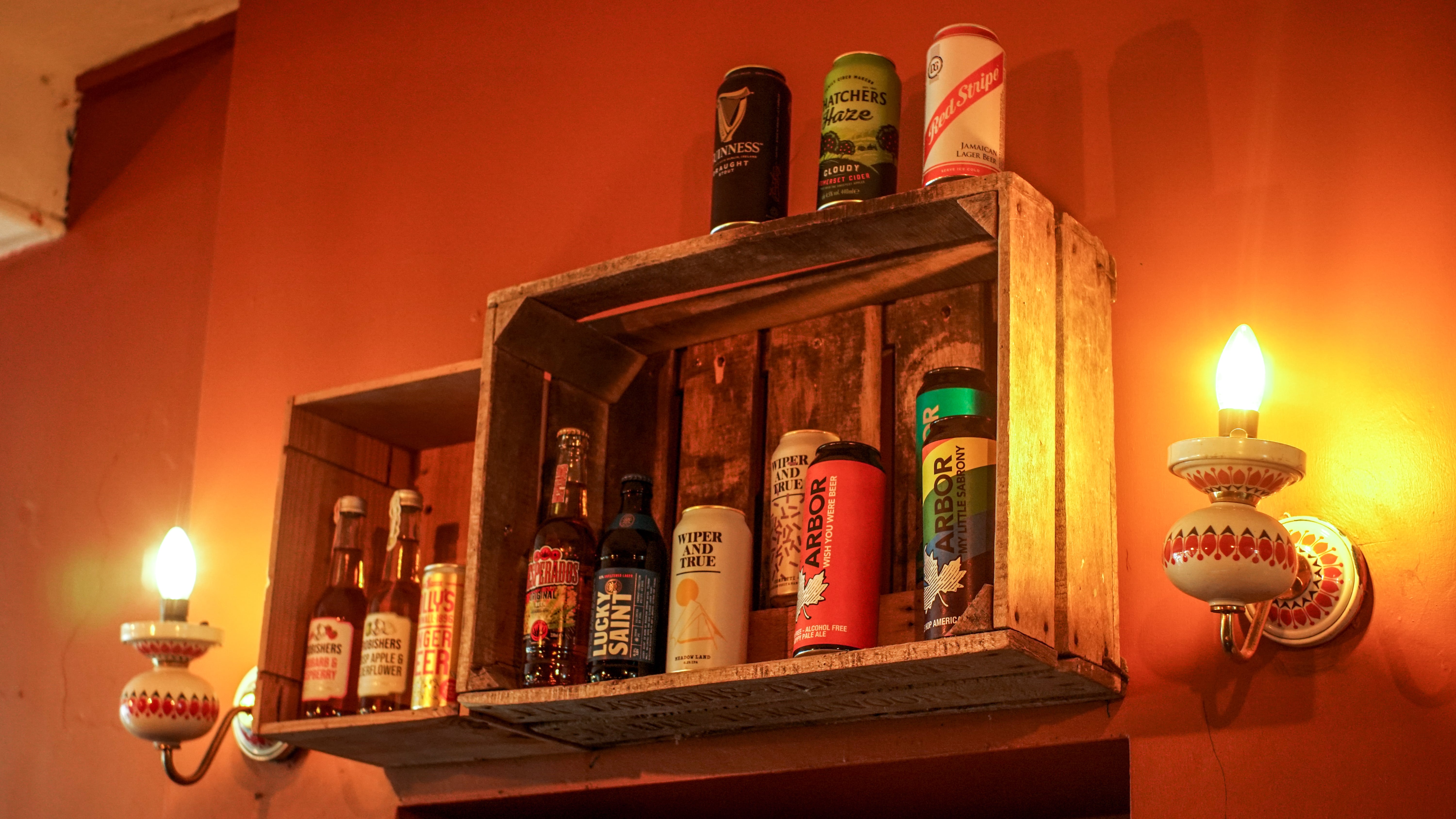 Cloak Cafe/Bar beverage display with rustic crate, ideal for events and gatherings.