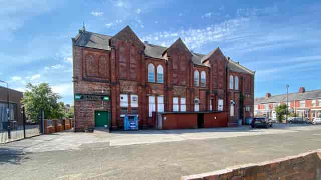 Main function room at St Alphonsus Parish Centre, ideal for events with charming brick exterior.