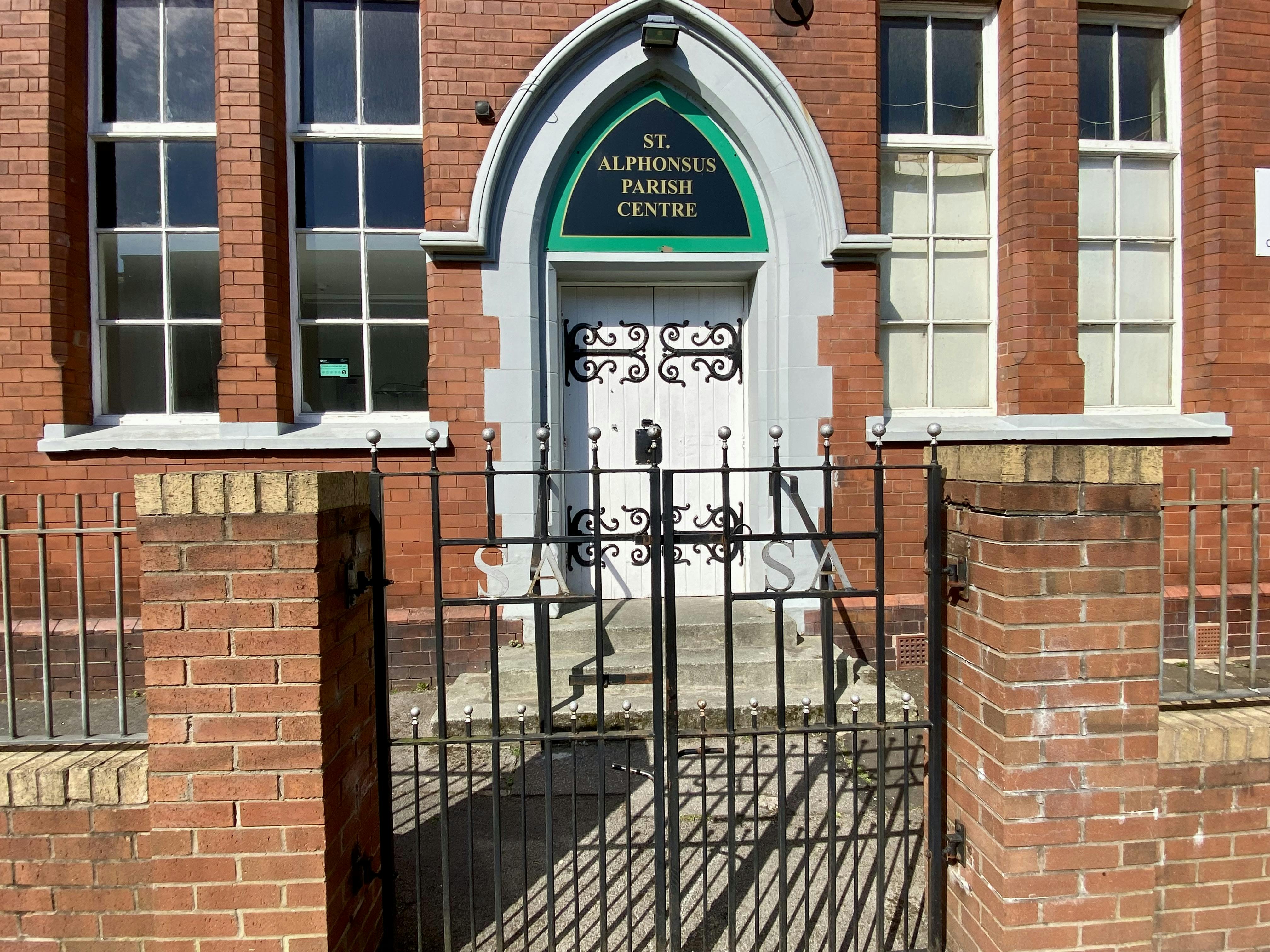 St Alphonsus Parish Centre entrance with large windows, ideal for community events and gatherings.