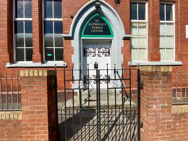 St Alphonsus Parish Centre entrance with large windows, ideal for community events.