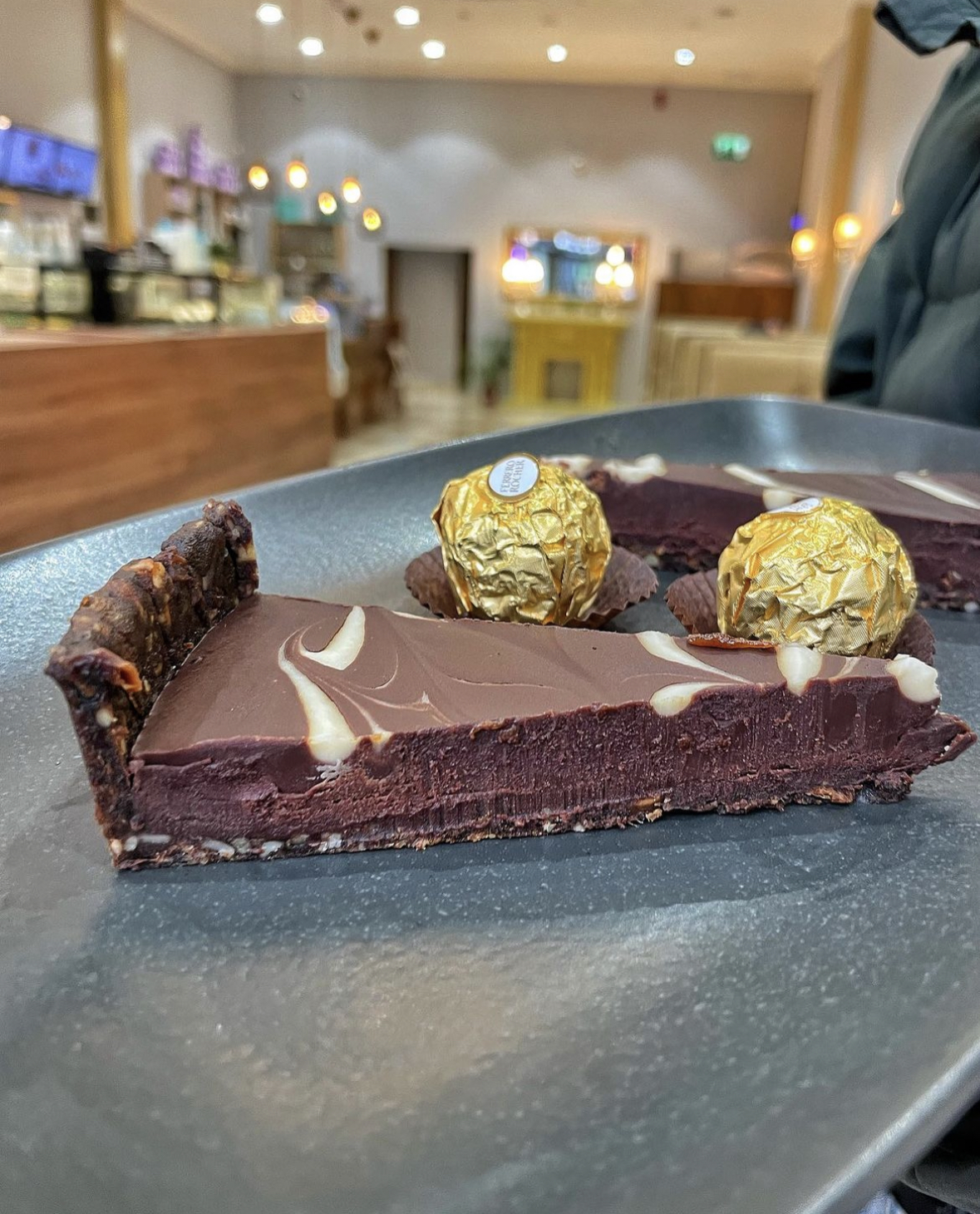 Elegant dessert platter with chocolate tart and gold truffles for upscale events. - Banner