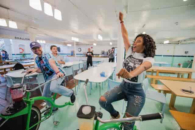 Team-building activity at Away Days with participants biking in a bright, casual setting.