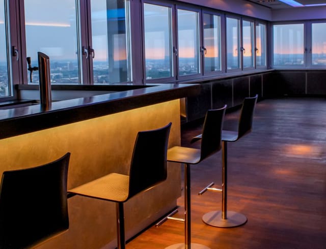 Modern bar area with city views, ideal for networking events and cocktail receptions.