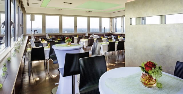 Modern event space at UP COLOGNE with elegant tables for corporate events and receptions.