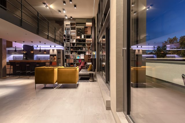 Modern rooftop event space with high ceilings, ideal for networking and gatherings.