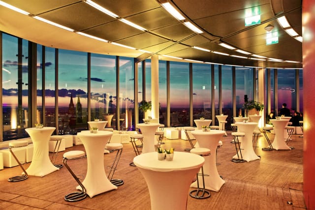 Sophisticated event space in Koelnsky with skyline view, perfect for networking and receptions.