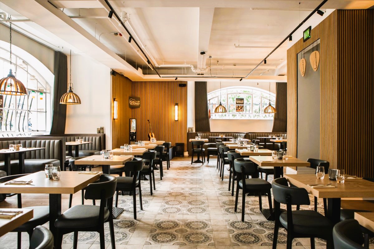 Modern Strings Restaurant with wooden accents, perfect for networking events and intimate dinners.