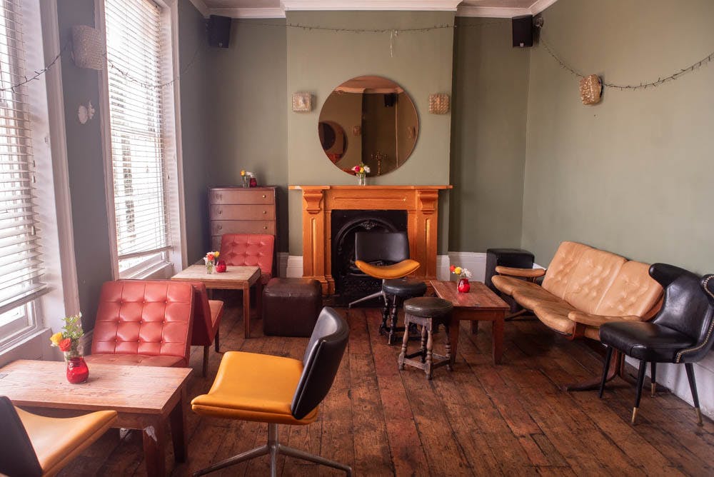 Cozy pub lounge with warm colors, perfect for networking events and meetings.