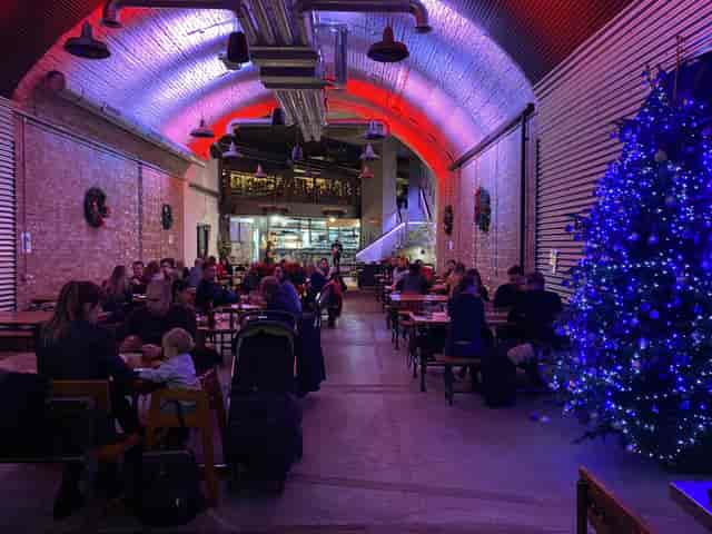 Vibrant event space with festive decor at The Old Arch, perfect for holiday gatherings.