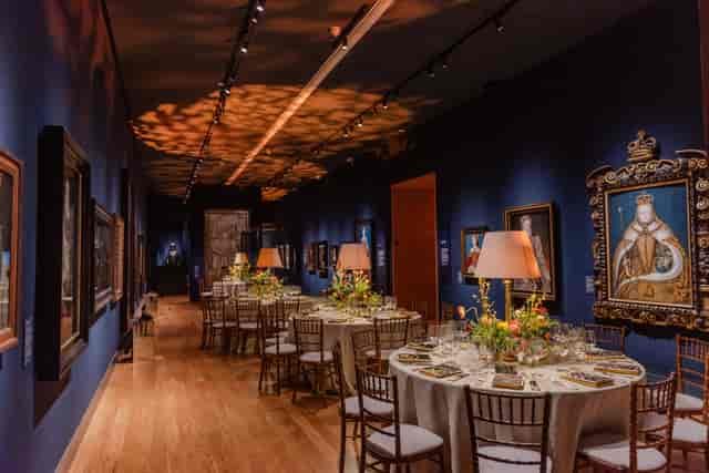 Elegant Tudor Galleries event space with floral centerpieces, ideal for corporate gatherings.