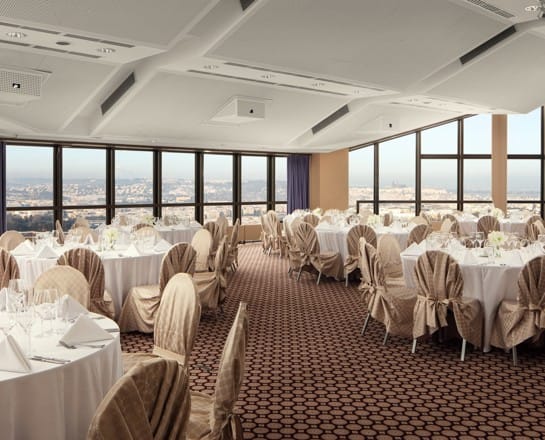 Elegant event space with round tables, ideal for weddings and corporate events in Prague.