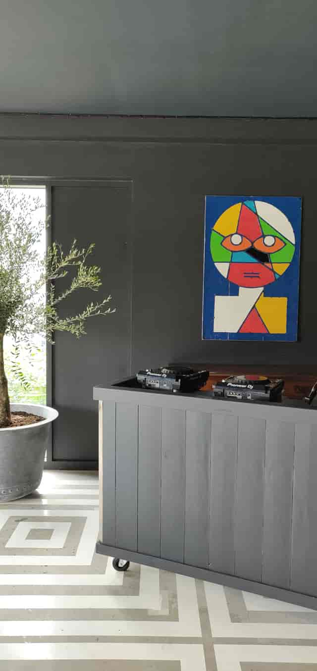 Stylish event space at Nico's Bar, Hackney Bridge, with DJ turntables and olive tree.