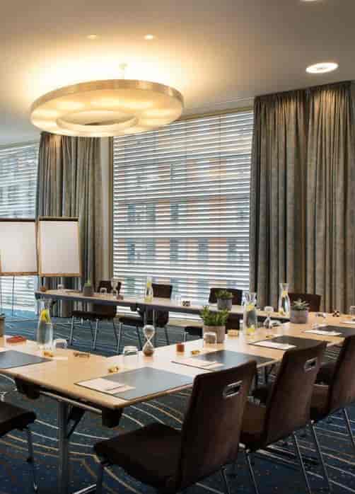 Meeting room in Renaissance Zurich Tower, featuring a long table and natural light.