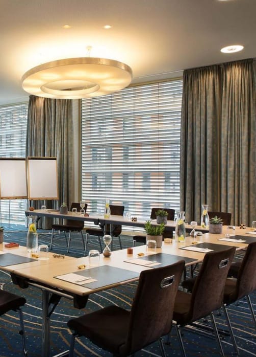 Meeting room in Renaissance Zurich Tower, featuring a long table and natural light.