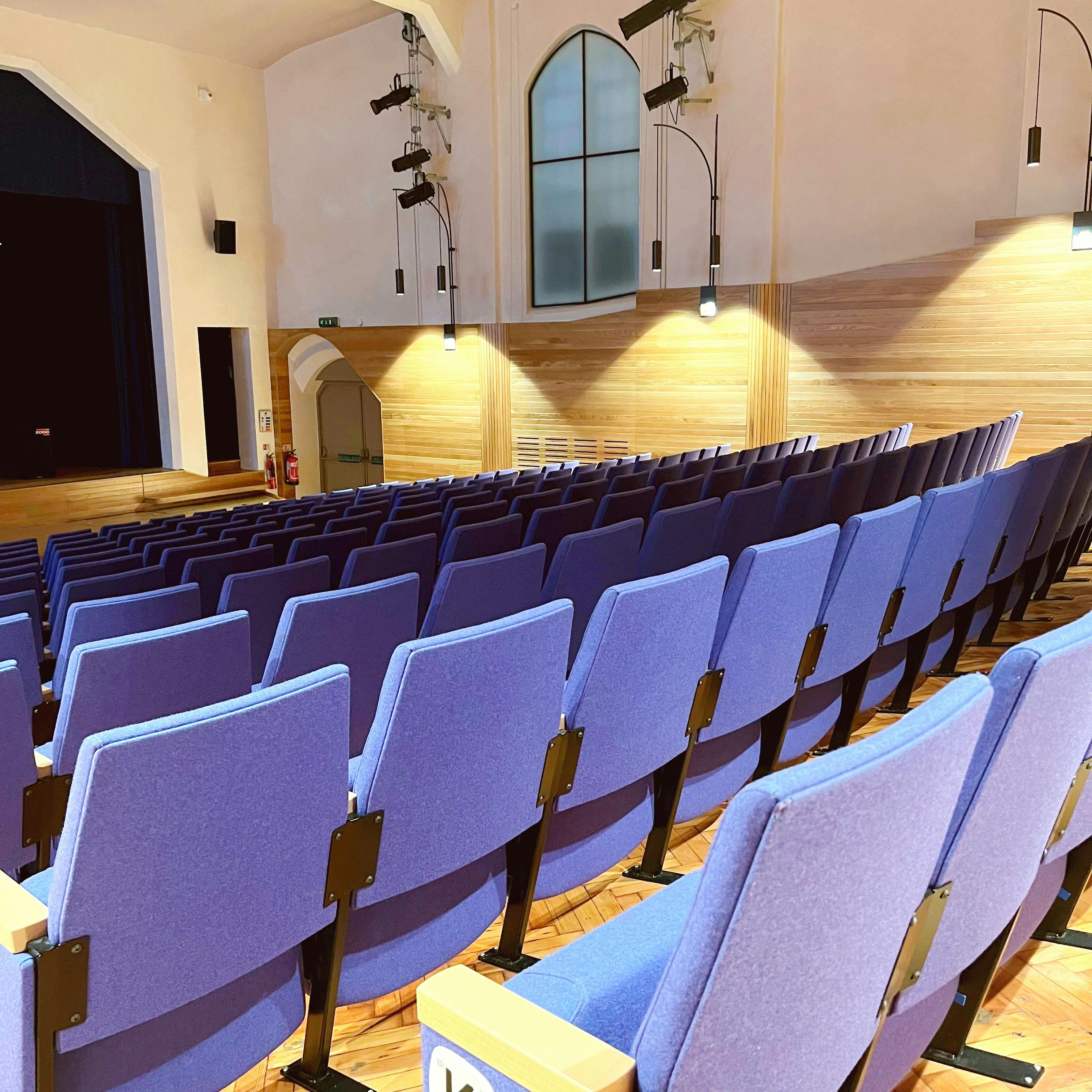 Marylebone Theatre auditorium with purple seating, ideal for conferences and workshops.