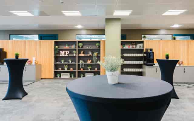Modern event space at Millennium Point with sleek high-top tables for networking.