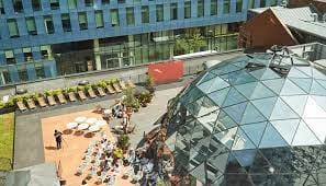 Modern outdoor event space with glass dome, ideal for corporate events and social gatherings.