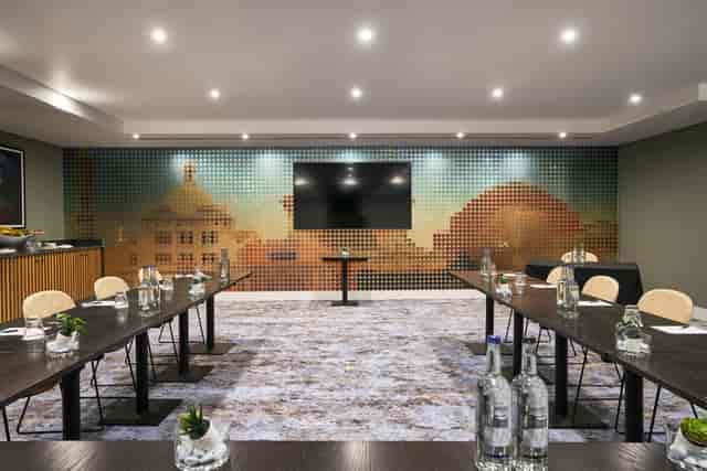Modern meeting room at The Cumberland Hotel with vibrant decor for professional events.
