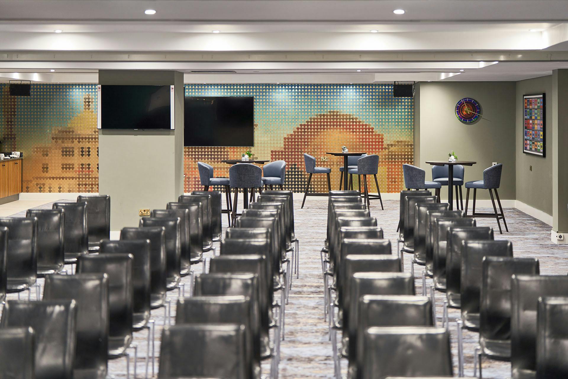 Versatile event space at The Cumberland Hotel with sleek chairs for meetings and gatherings.