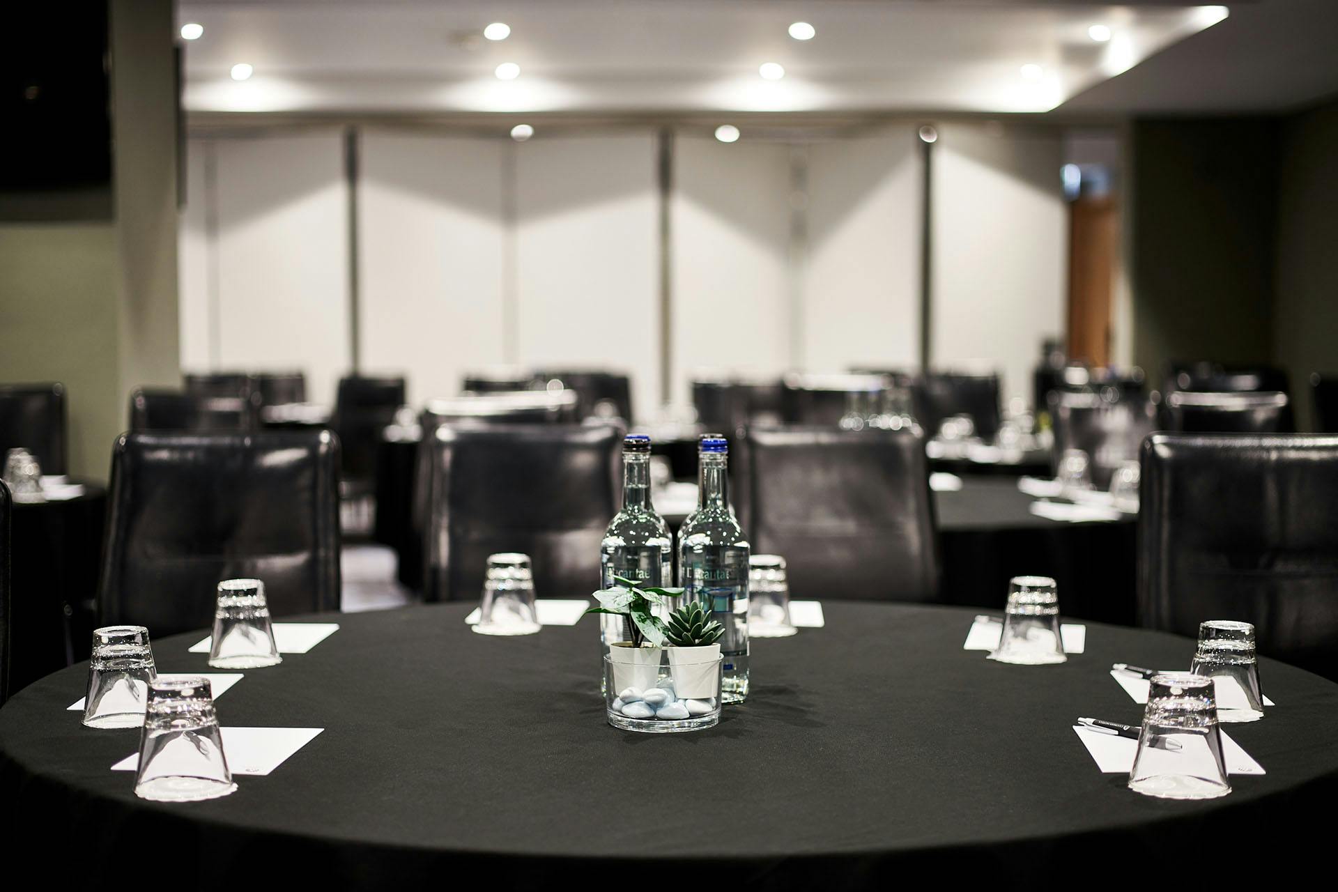 Meeting room at The Cumberland Hotel with round tables, ideal for workshops and conferences.