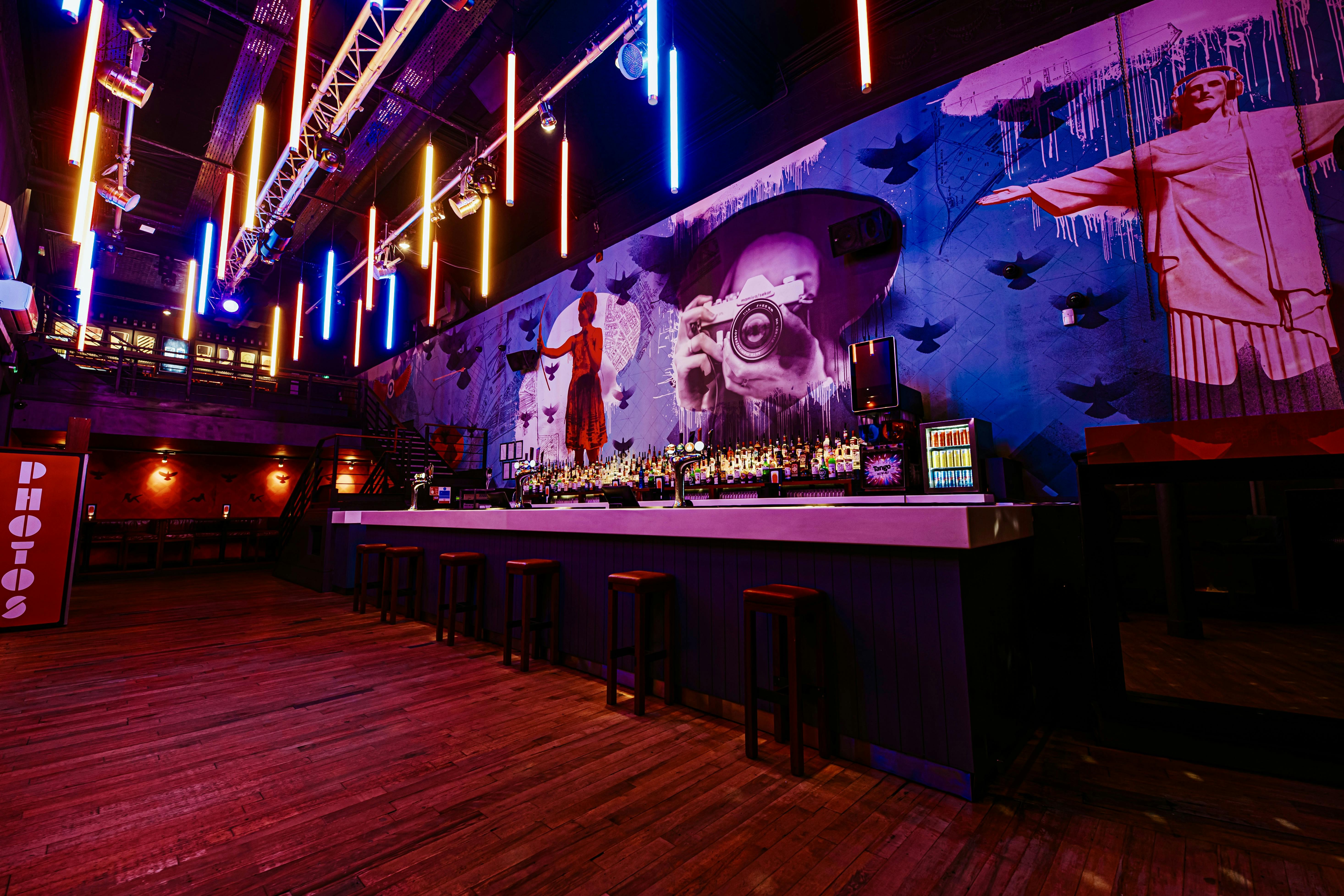 Vibrant event space at Baa Bar Nottingham with stylish bar and artistic mural.