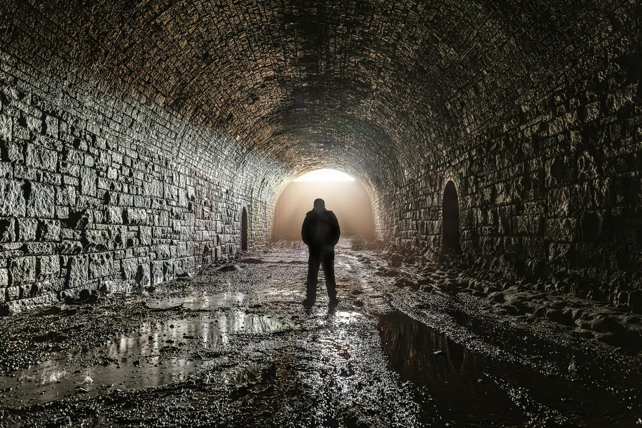 Disused railway tunnel with dramatic lighting, perfect for immersive events and workshops.