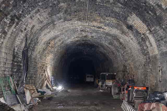 Disused railway tunnel with rugged stone walls for unique immersive events.