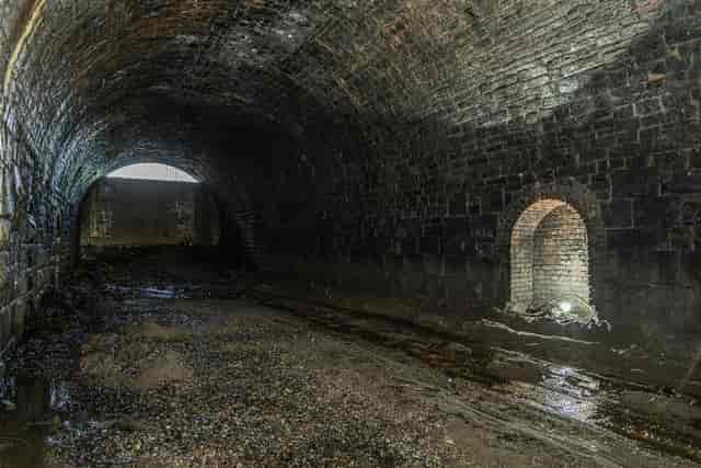 Disused railway tunnel with stone walls, perfect for immersive events and gatherings.