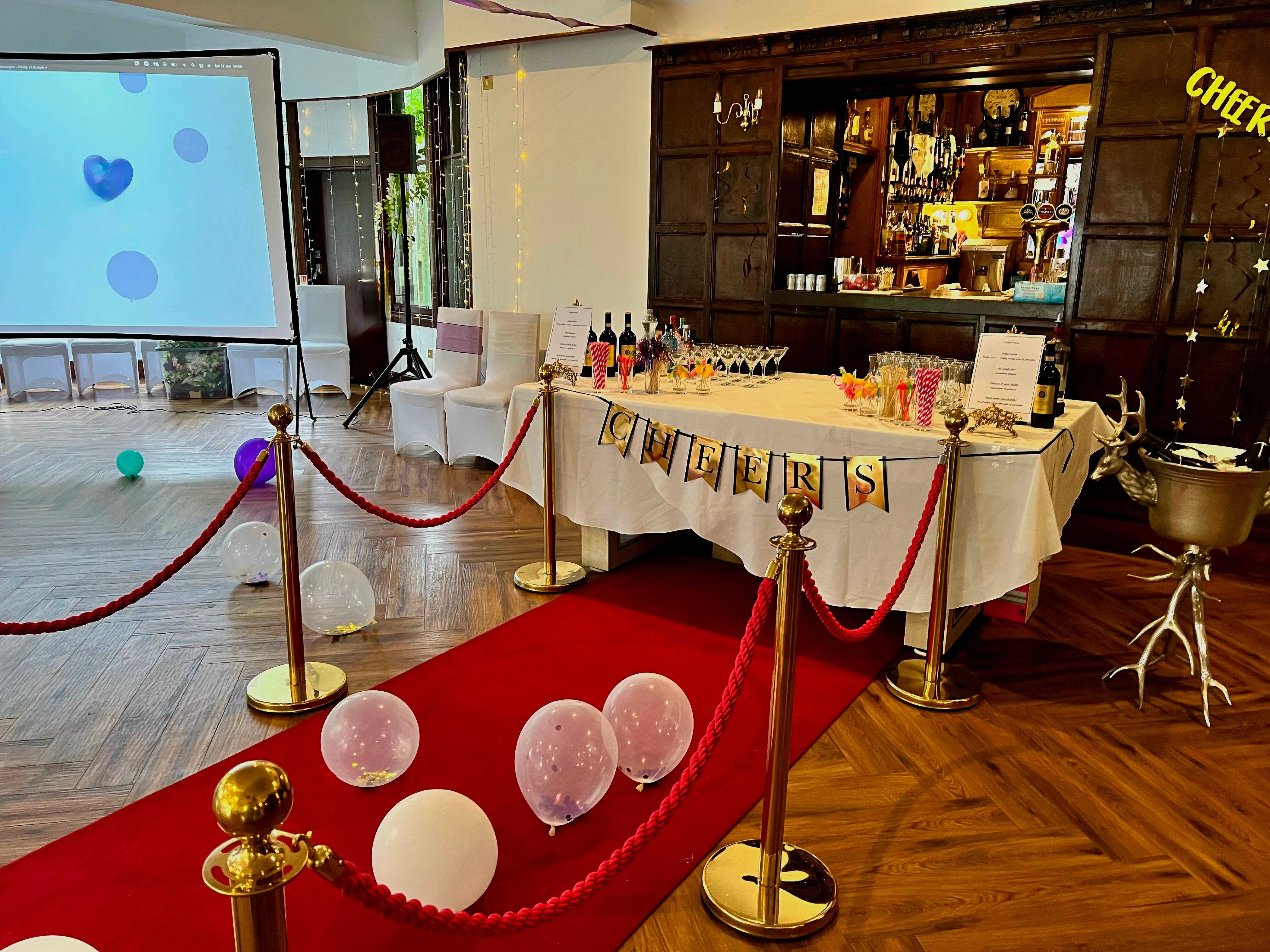 Elegant event space with red carpet, ideal for celebrations and corporate gatherings.