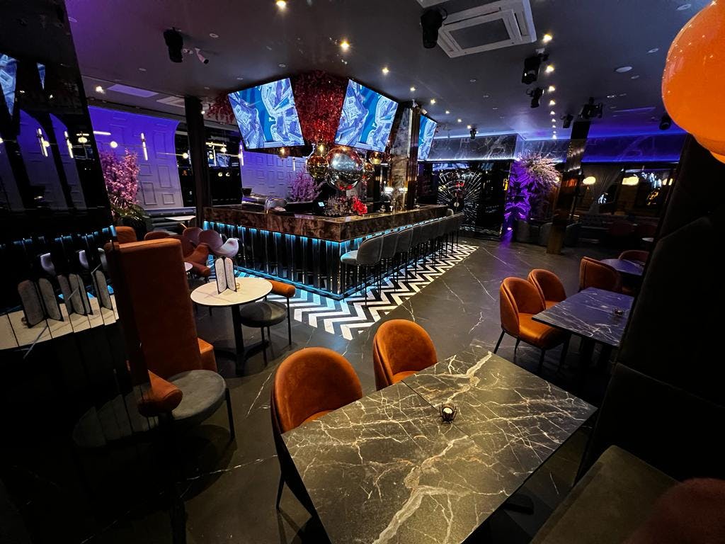 Stylish event space at Pizza Loca with modern bar, ideal for upscale gatherings.