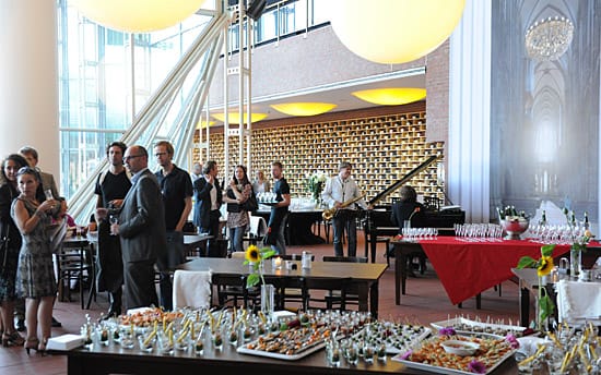 Elegant event setup at Ludwig im Museum with gourmet hors d'oeuvres and live piano music.