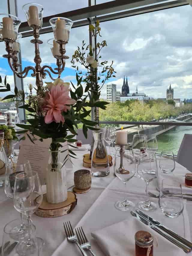 Elegant dining table with city view at Schokoladen Museum for upscale events.