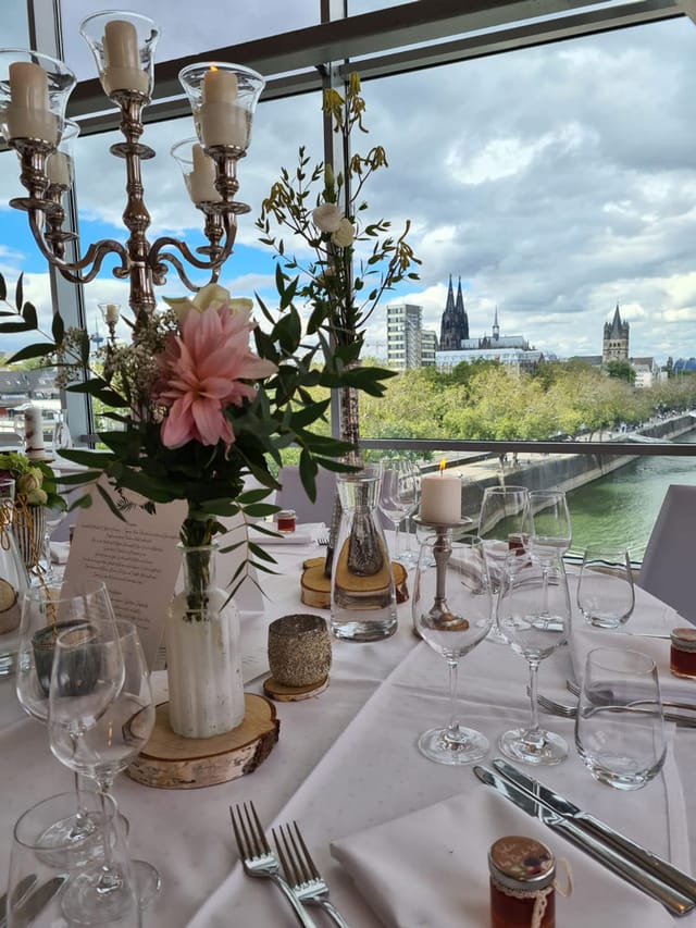 Elegant dining table with city view at Schokoladen Museum for upscale events.