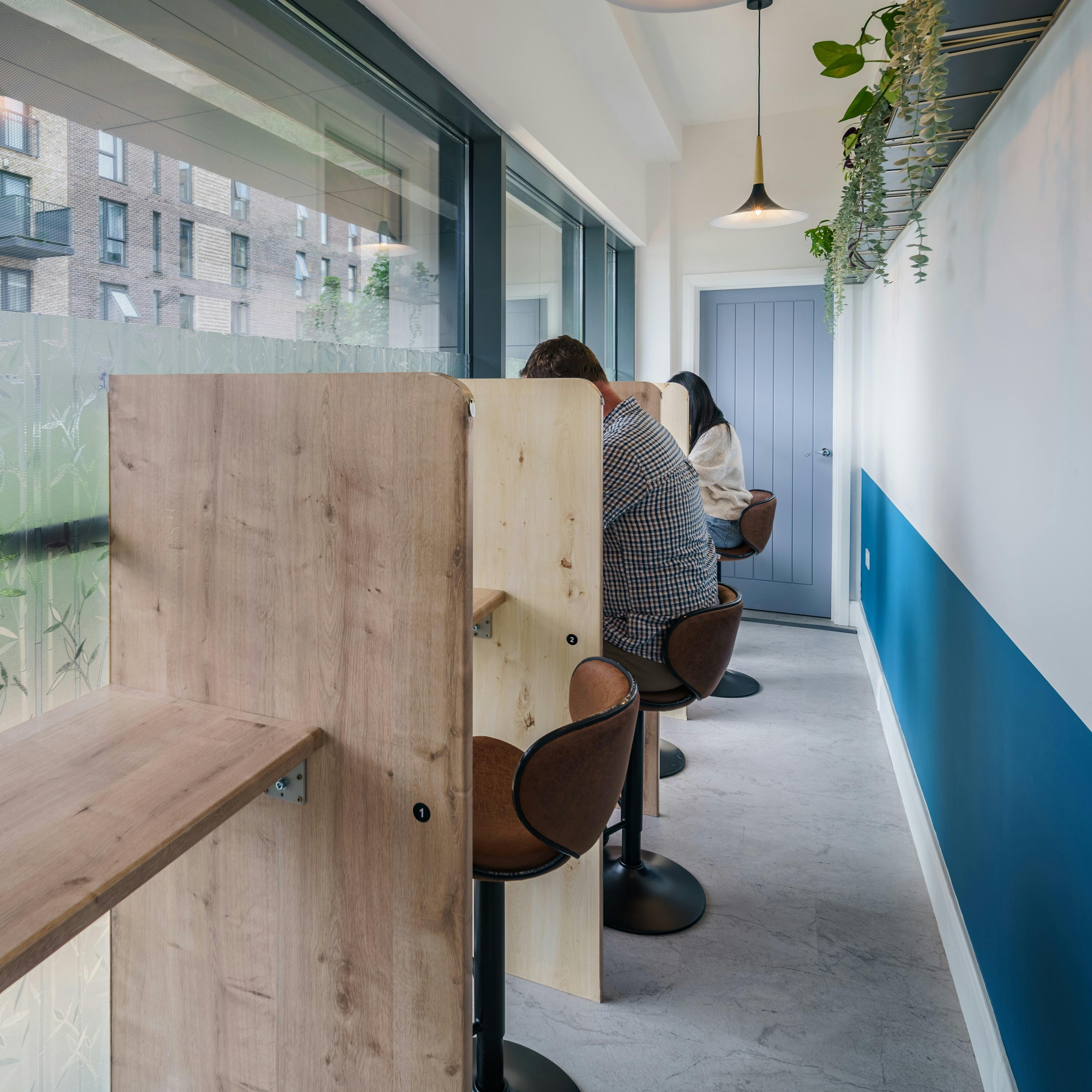 Modern hybrid meeting space with private booths for focused collaboration and productivity.
