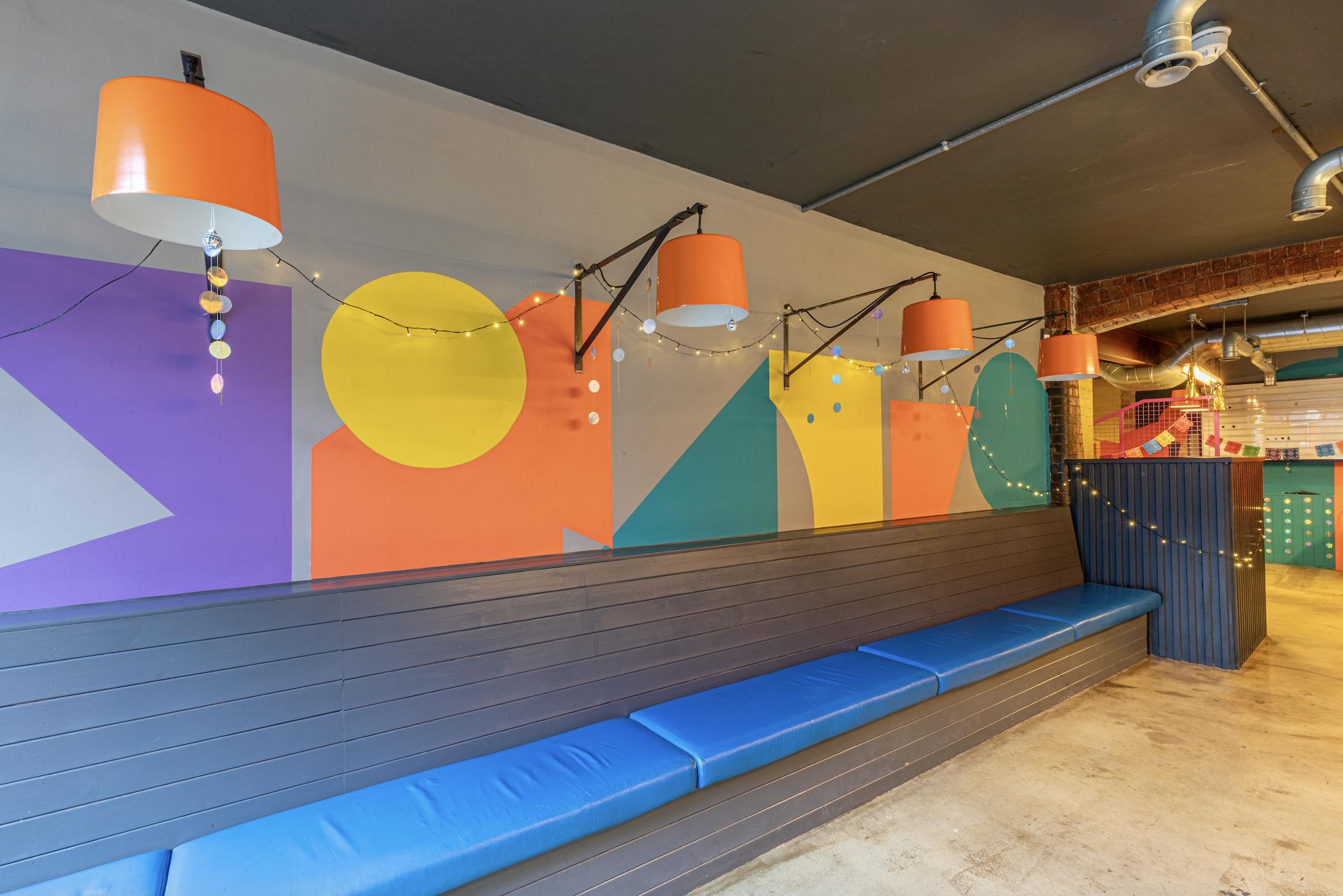Vibrant Medley Market event space with colorful wall art for networking and gatherings.