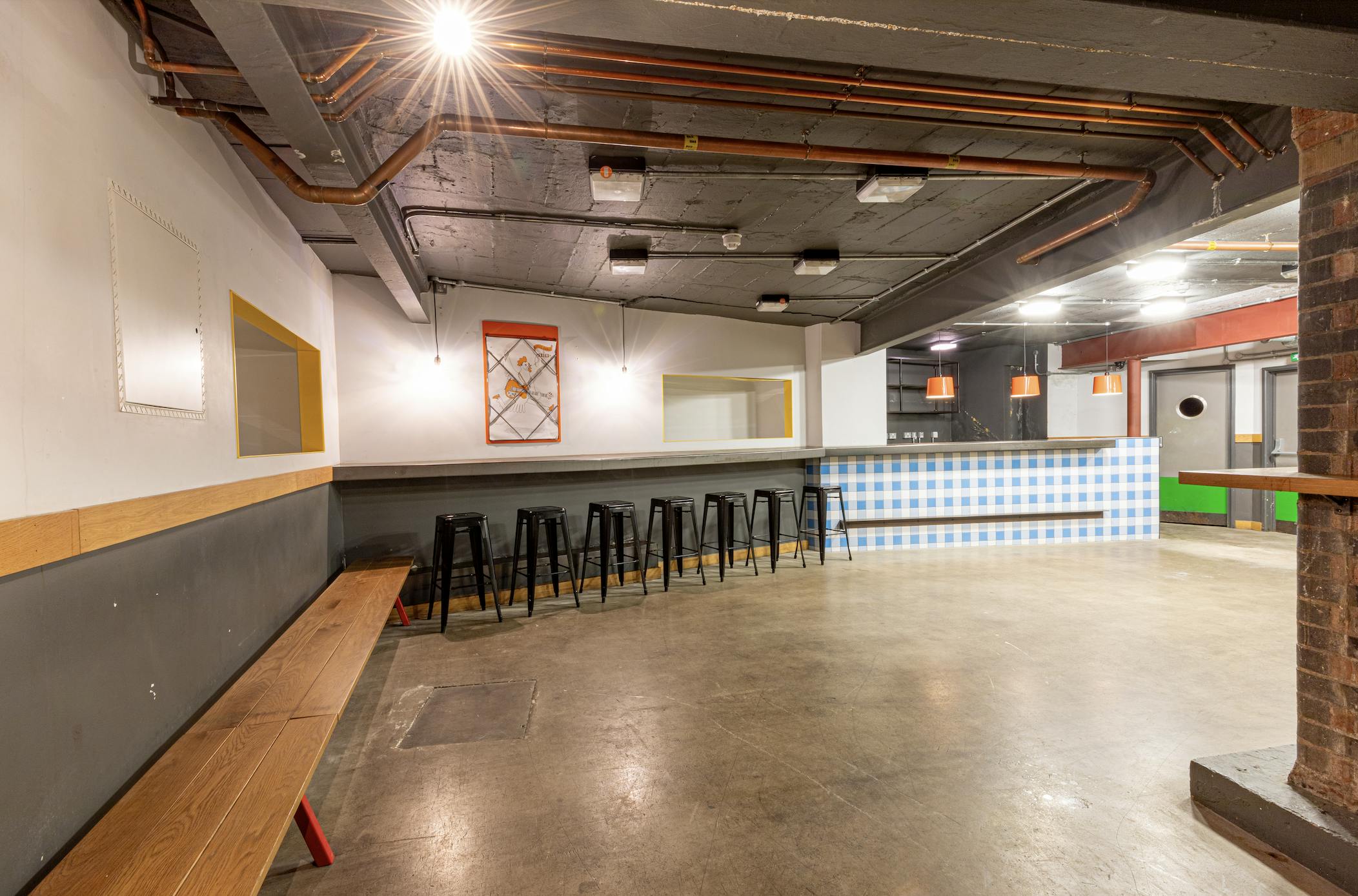 Versatile industrial event space with polished concrete floors for meetings and gatherings.