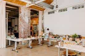 Versatile event space in Watt Factory with rustic brick walls for workshops and networking.