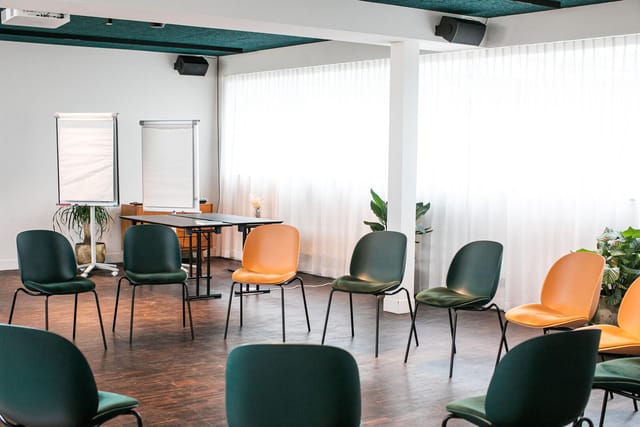 Conference room at Yalo Hotel with circular seating for workshops and team-building.