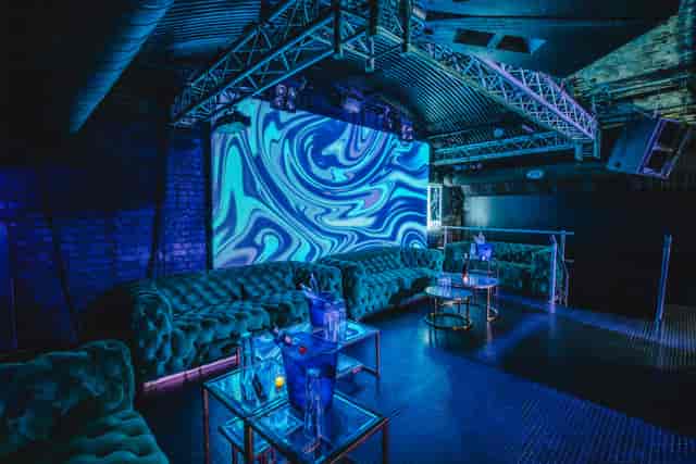 Fire Mirror Arch event space with plush seating, ideal for networking and private parties.