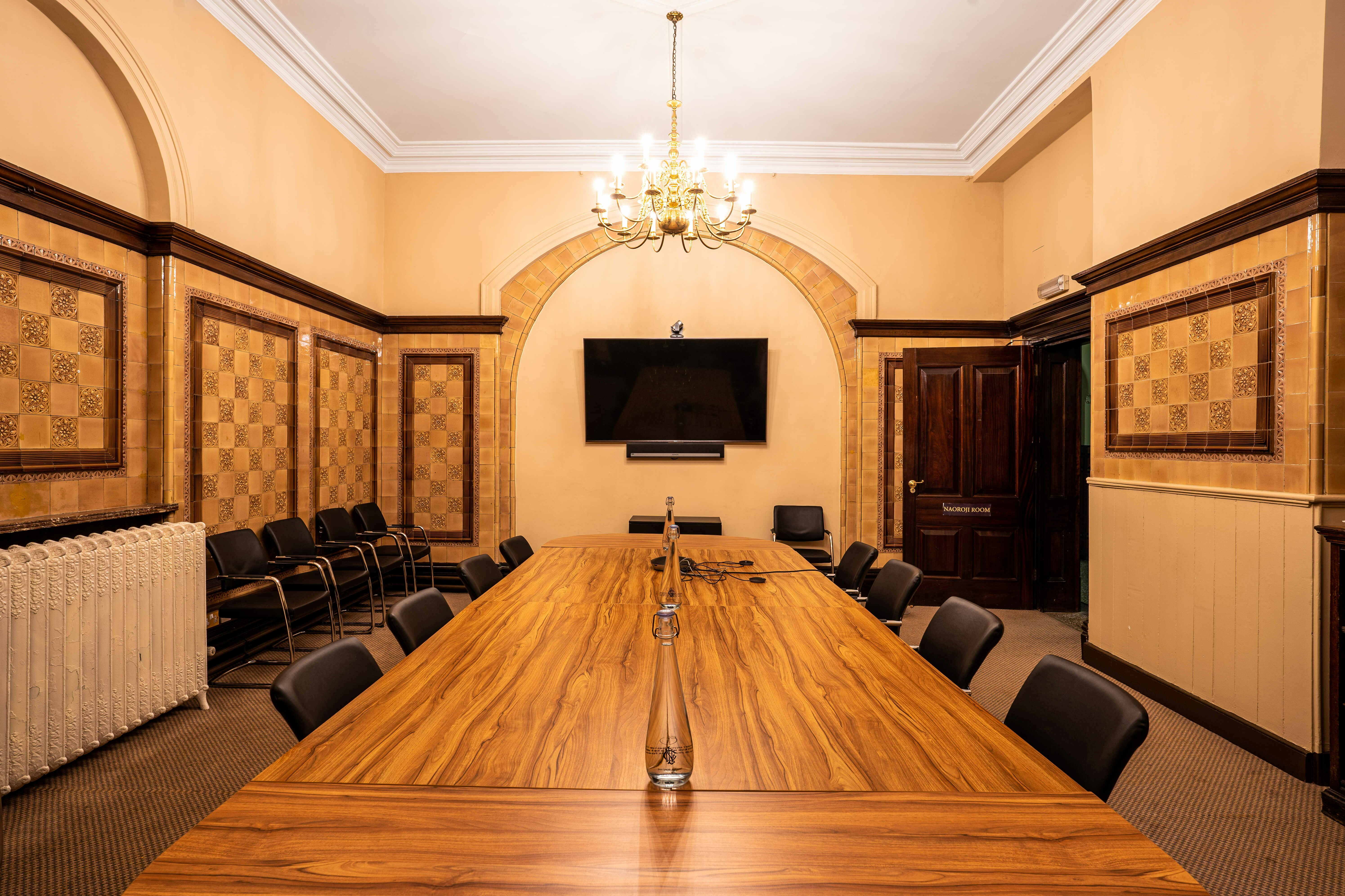 Naoroji Room at National Liberal Club: elegant meeting space with wooden table, ideal for events.