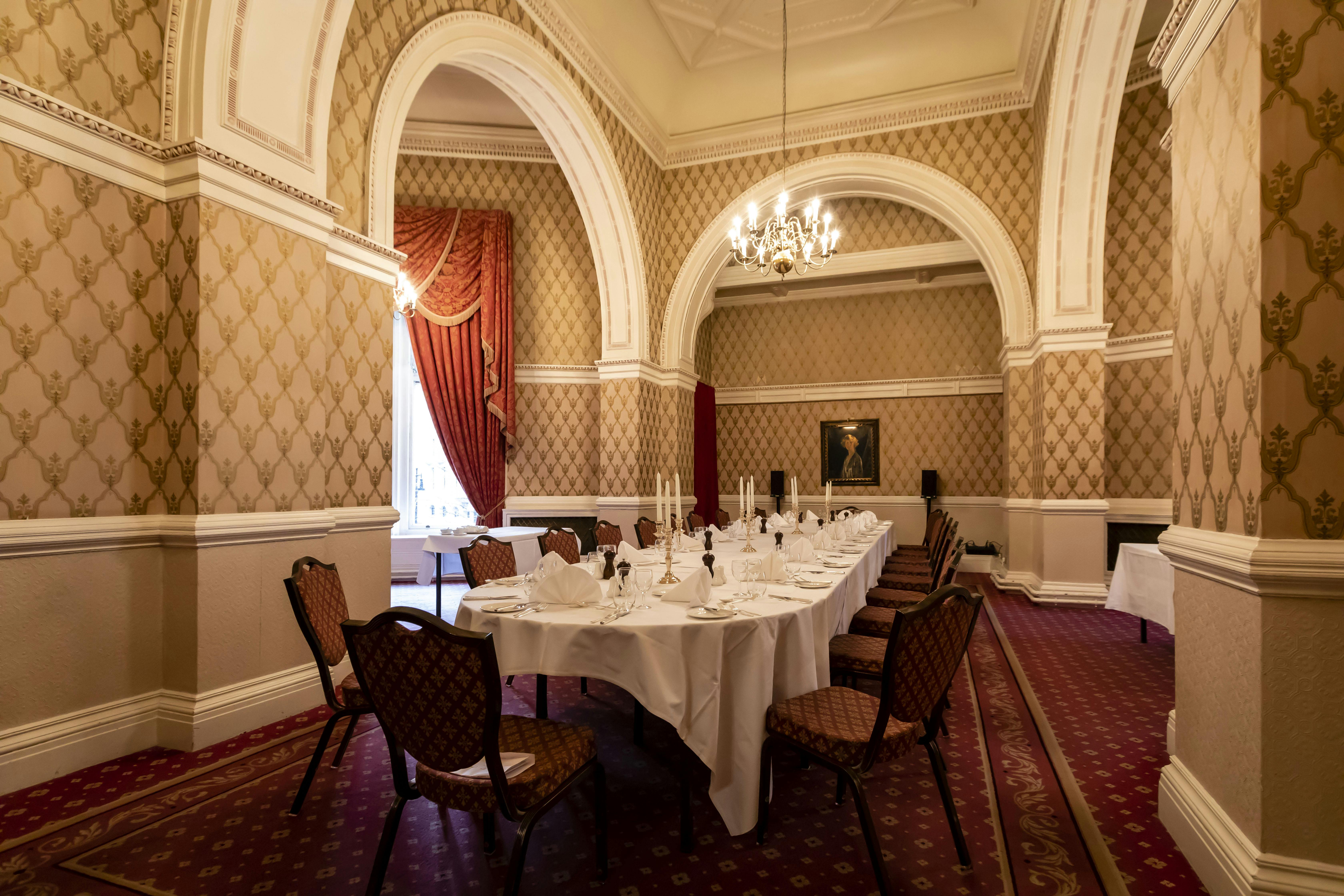 Elegant dining room in Lady Violet Room, perfect for corporate dinners and private events.