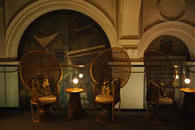 Stylish lounge with rattan chairs in The Hidden Garden for events and networking.