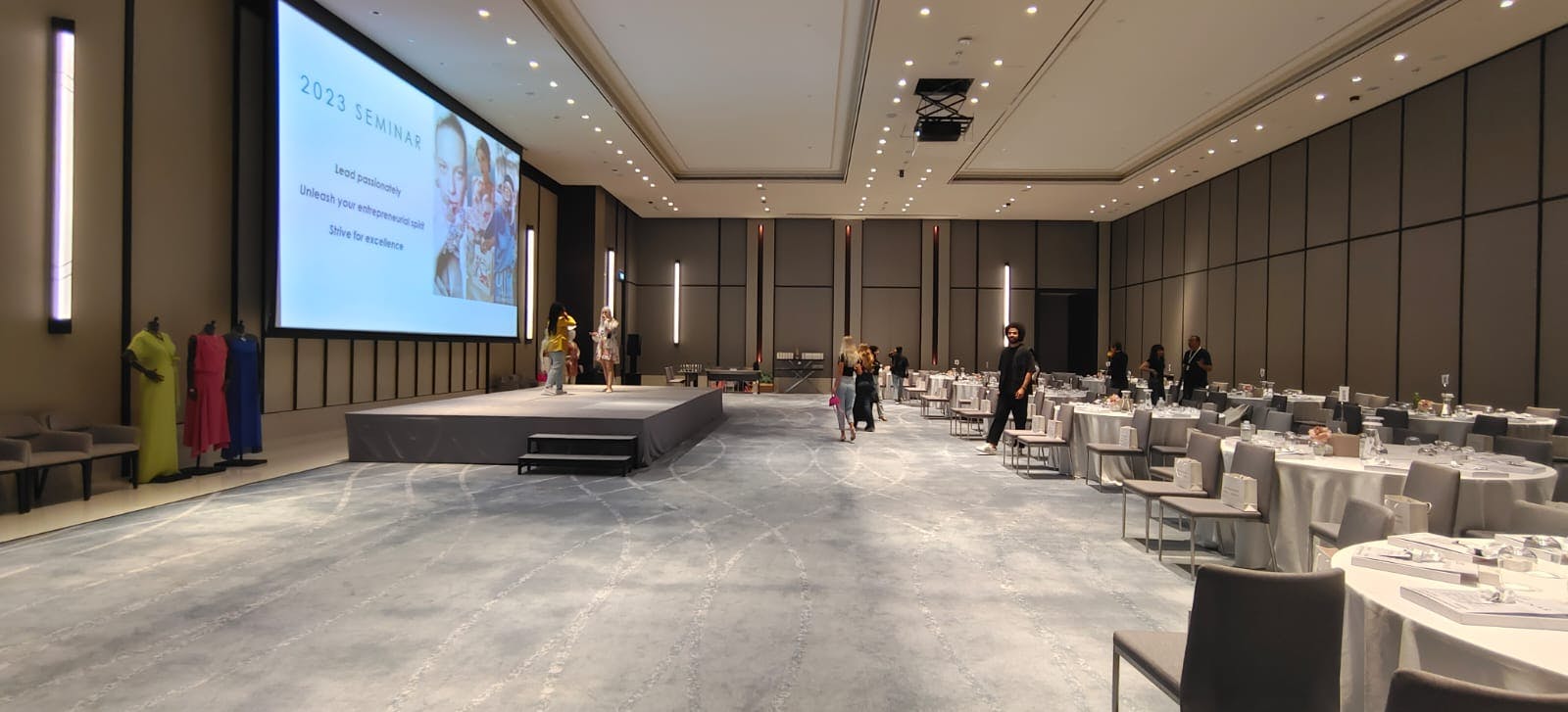 Sky View Ballroom seminar setup with stage, tables, and modern decor for events.