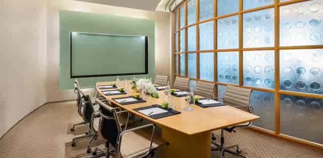 Al Nojoom Grand Ballroom, modern conference room with oval table, ideal for meetings and events.