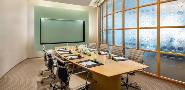 Al Nojoom Grand Ballroom, modern conference room with oval table, ideal for meetings and events.