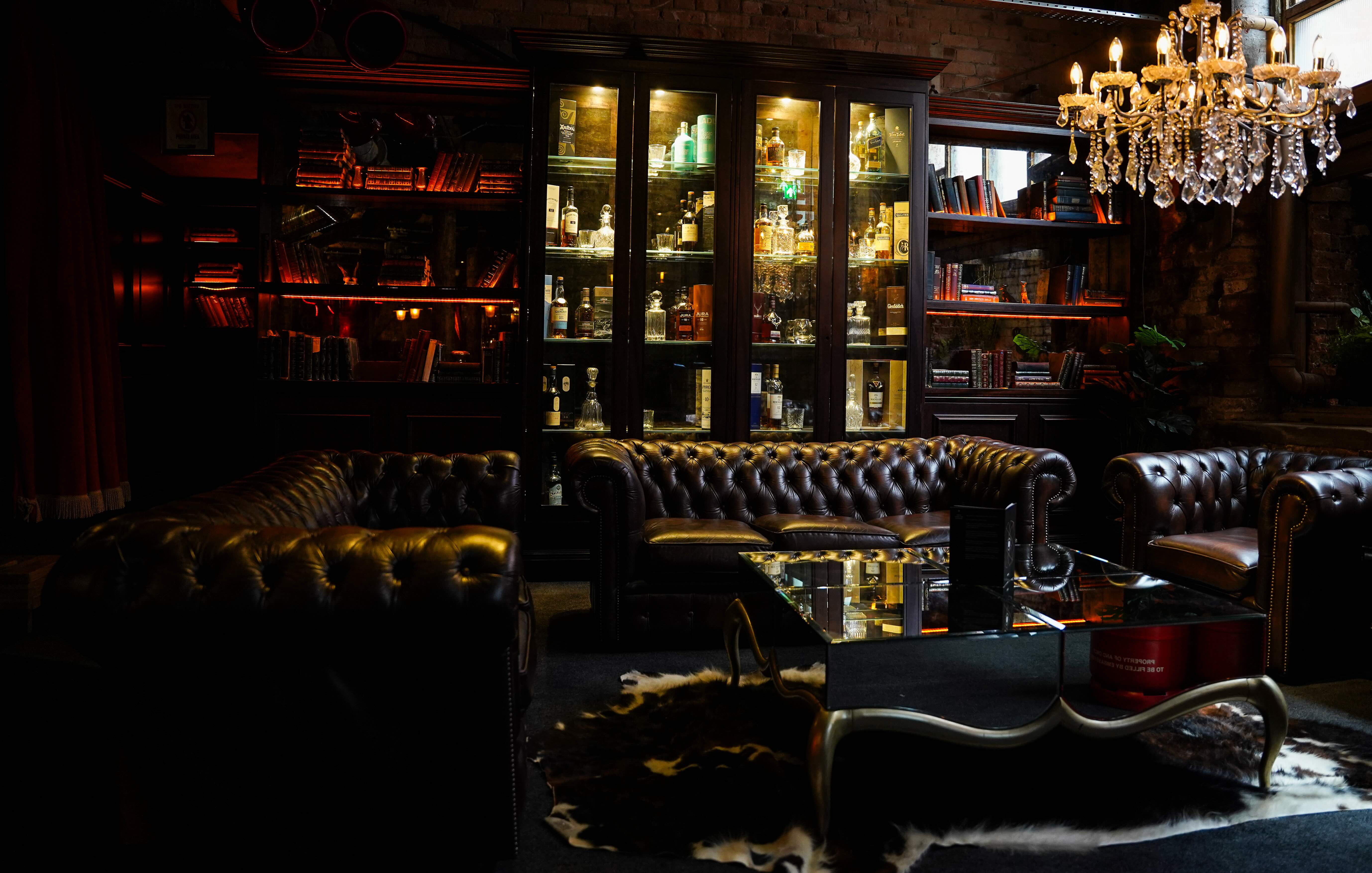Sophisticated lounge with plush leather seating for networking events in Whiskey Down. - Banner
