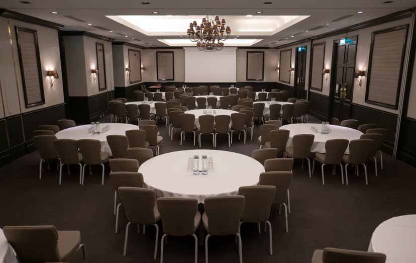 Elegant banquet setup in Pentahotel Reading with round tables and AV screen.